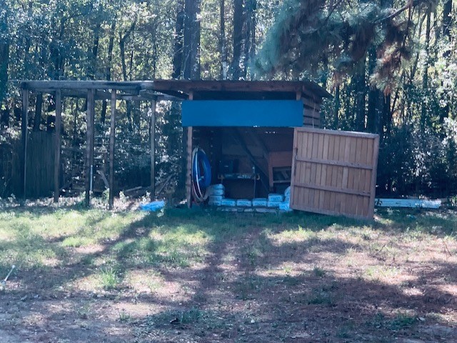 284 County Road 3405 Cleveland, TX 77327 - Photo 20 of 22 a view of backyard with wooden fence