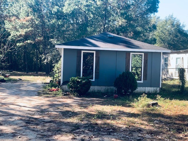 284 County Road 3405 Cleveland, TX 77327 - Photo 2 of 22 a front view of a house with garden
