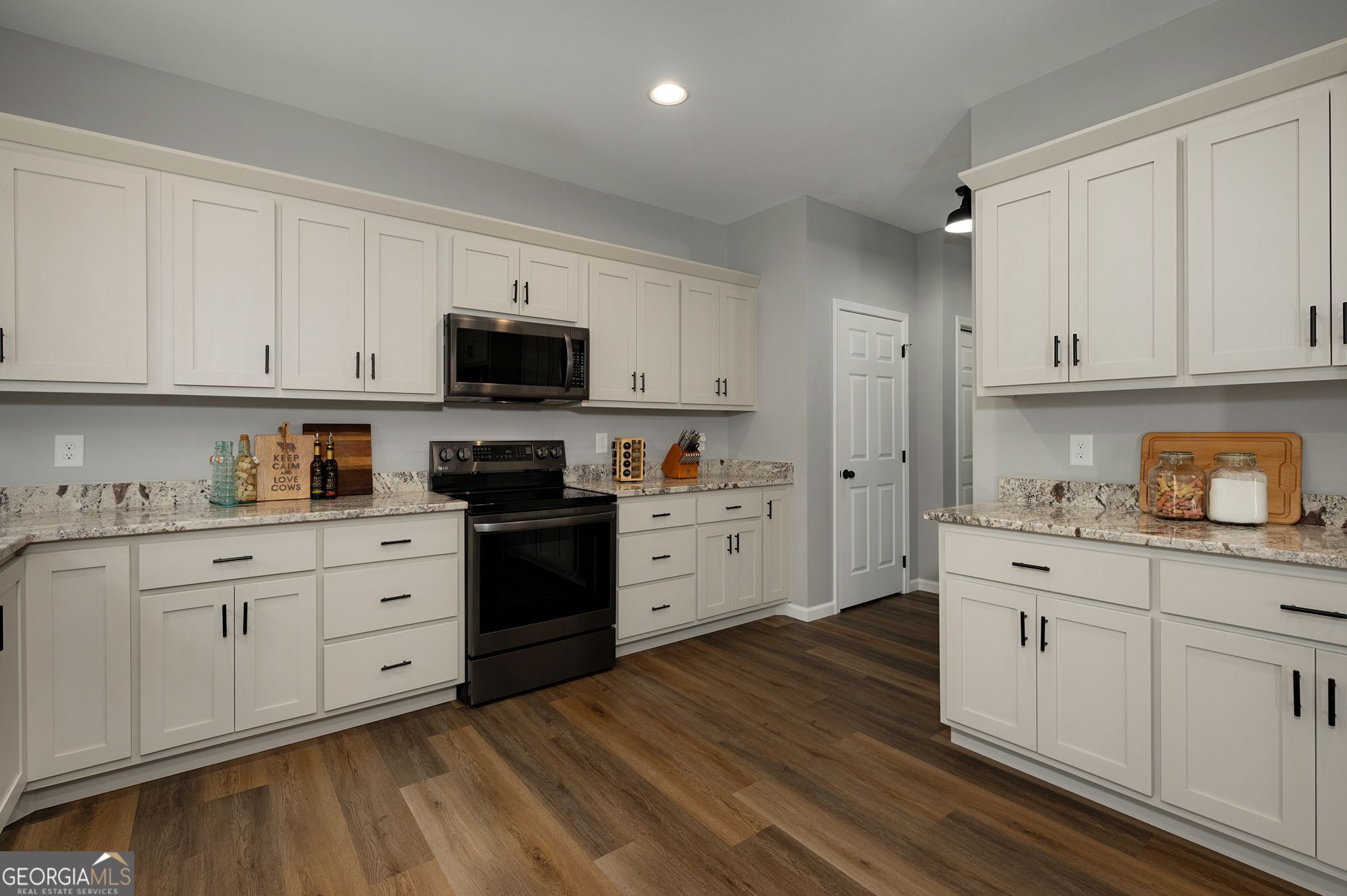 146 Hackney Trail Ellijay, GA 30536 - Photo 11 of 24 a kitchen with granite countertop white cabinets and black stainless steel appliances