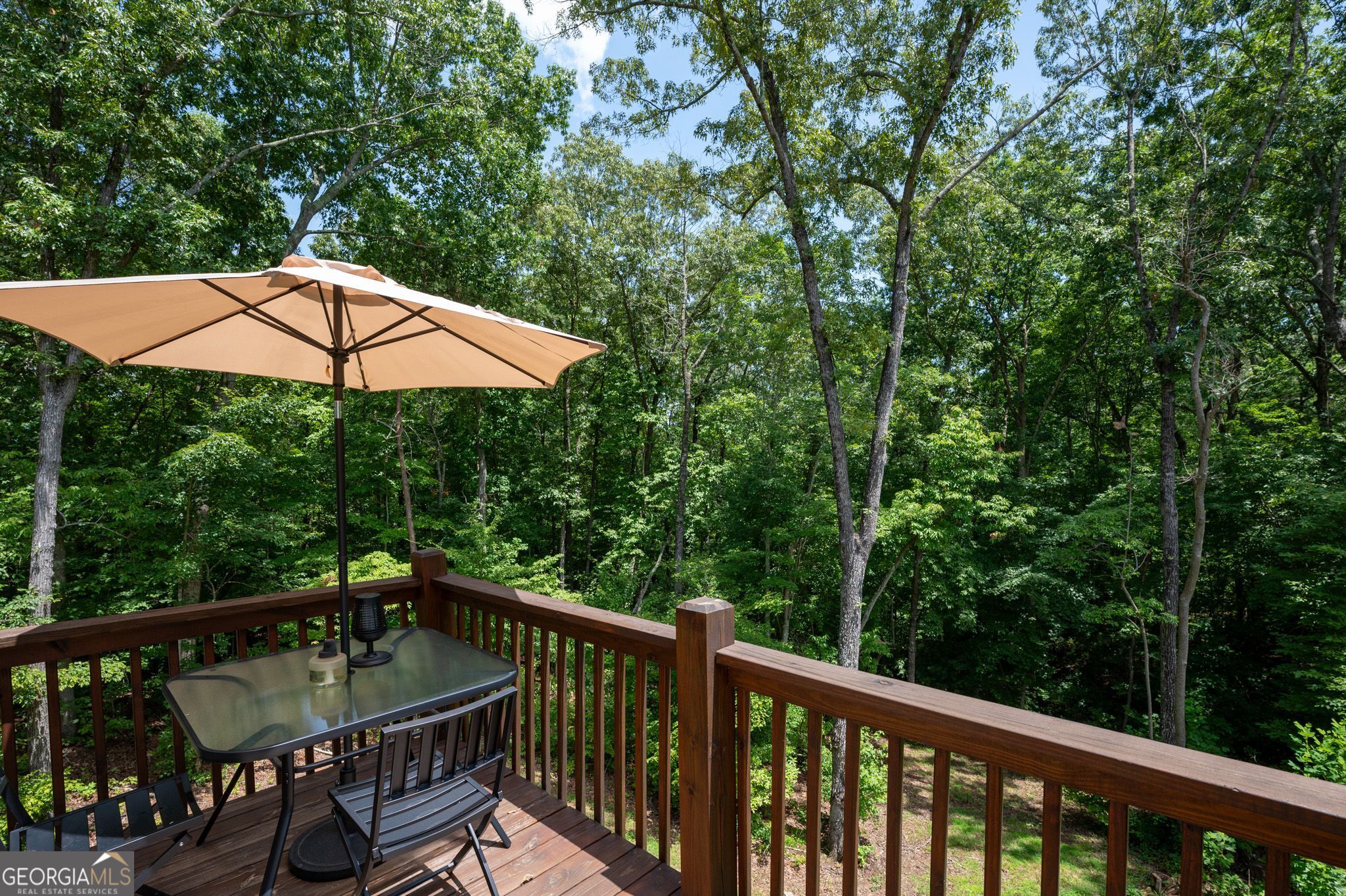 146 Hackney Trail Ellijay, GA 30536 - Photo 9 of 24 a view of a balcony with chairs and an umbrella