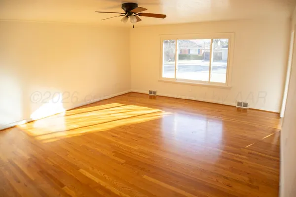 a spacious bathroom with a granite countertop sink and a mirror