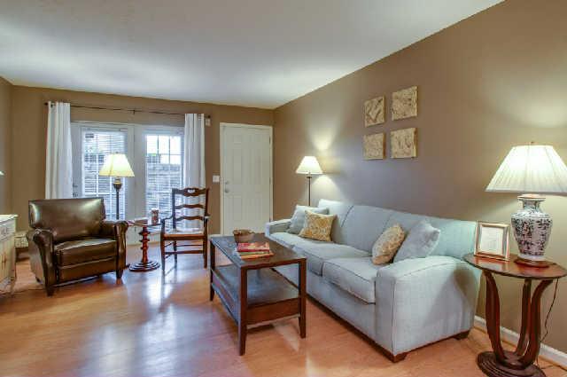 a living room with furniture and a lamp