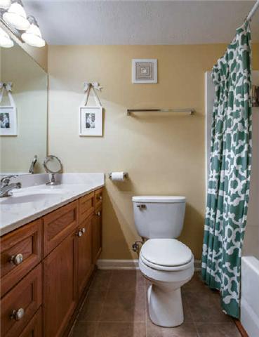 420 Elysian Fields Road, Unit E10 Nashville, TN 37211 - Photo 16 of 20 a bathroom with a granite countertop toilet sink and mirror