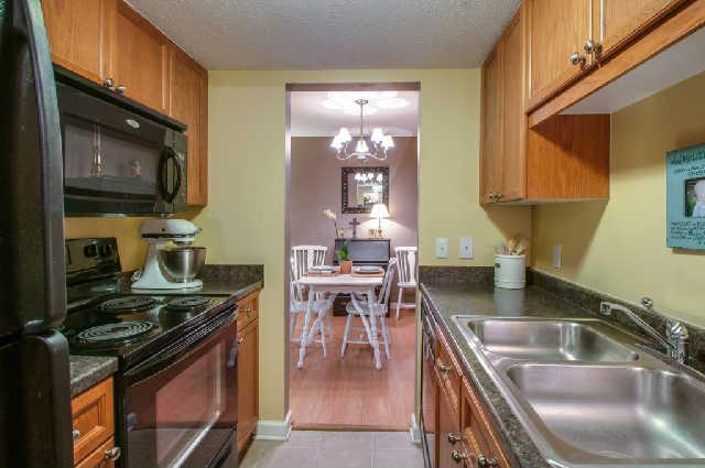 420 Elysian Fields Road, Unit E10 Nashville, TN 37211 - Photo 8 of 20 a kitchen with granite countertop a stove top oven a sink a counter space and cabinets
