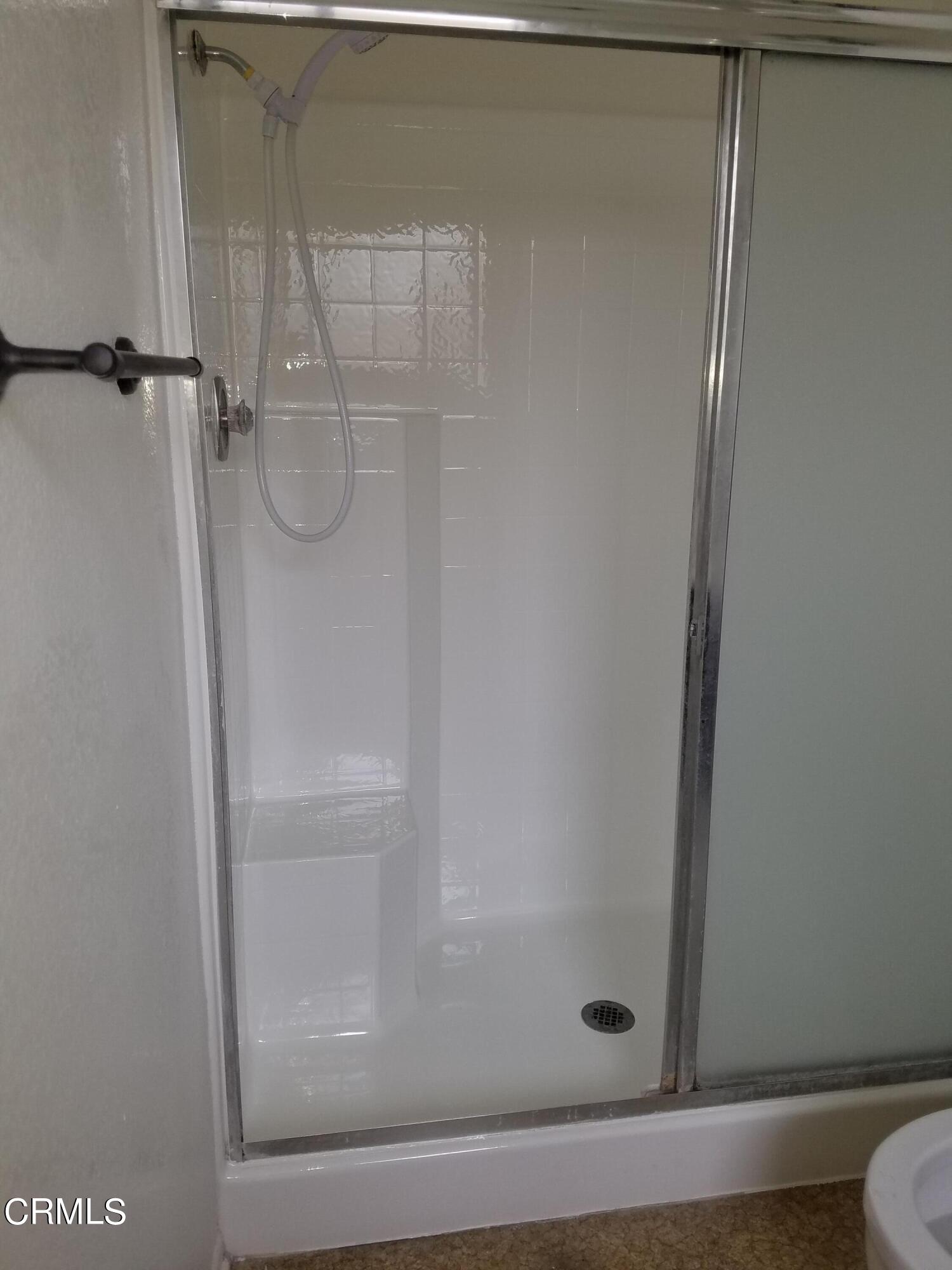 851 Almendra Place Oxnard, CA 93036 - Photo 5 of 7 a bathroom with a glass shower door