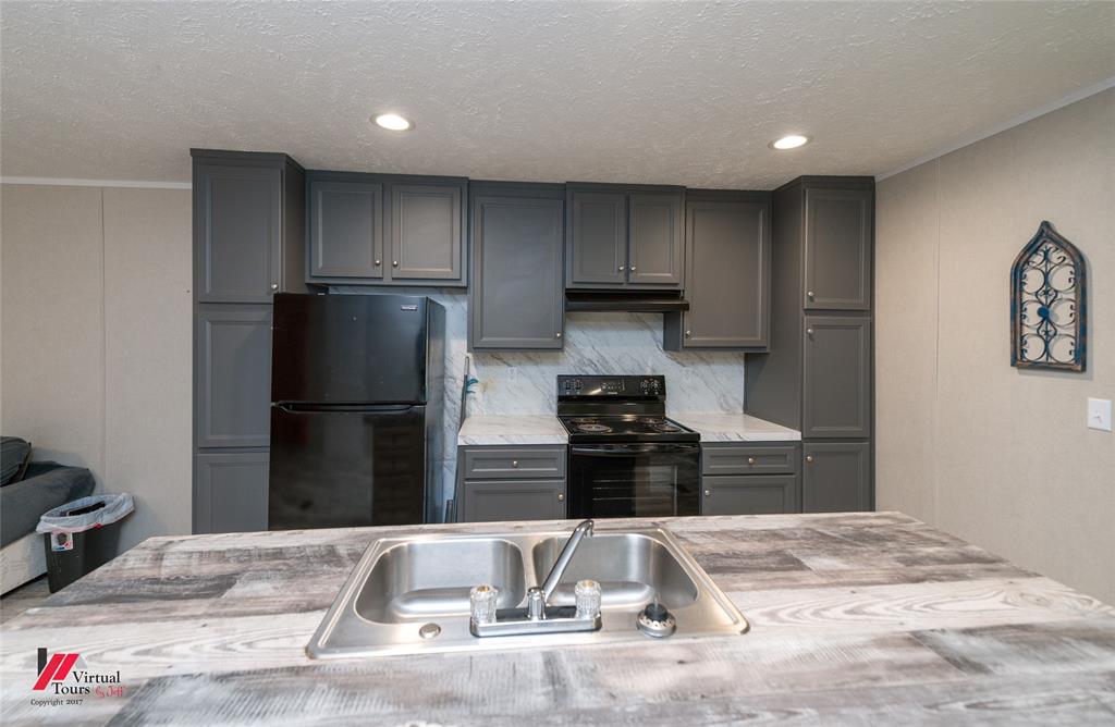 2470 Highway 792 Heflin, LA 71039 - Photo 11 of 25 a kitchen with a refrigerator and a stove top oven