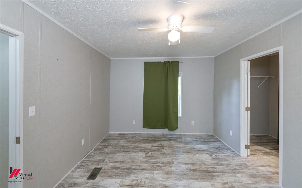2470 Highway 792 Heflin, LA 71039 - Photo 17 of 25 an empty room with closet and chandelier fan