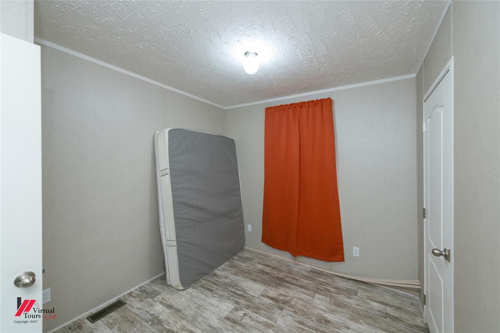 2470 Highway 792 Heflin, LA 71039 - Photo 22 of 25 an empty room with closet and wooden floor