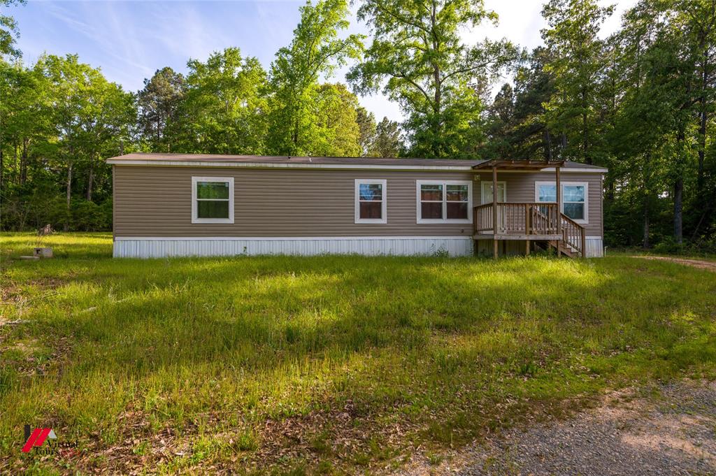 2470 Highway 792 Heflin, LA 71039 - Photo 4 of 25 a backyard of a house with garden and outdoor seating