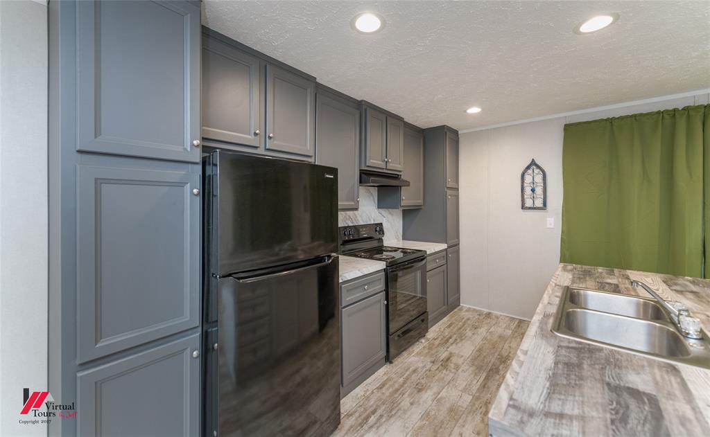 2470 Highway 792 Heflin, LA 71039 - Photo 8 of 25 a kitchen with a refrigerator and a sink