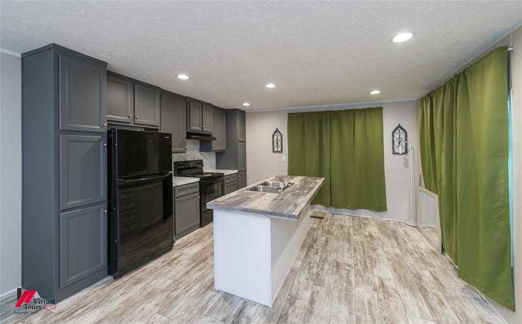 2470 Highway 792 Heflin, LA 71039 - Photo 9 of 25 a kitchen with kitchen island a counter top space cabinets and stainless steel appliances
