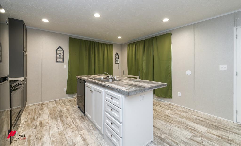 2470 Highway 792 Heflin, LA 71039 - Photo 10 of 25 a kitchen with kitchen island a sink stove and refrigerator