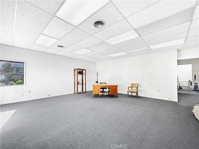 a view of a hallway with wooden shelves