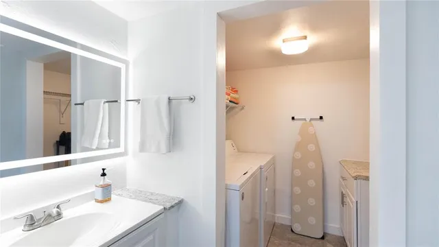 a bathroom with a sink vanity and a mirror