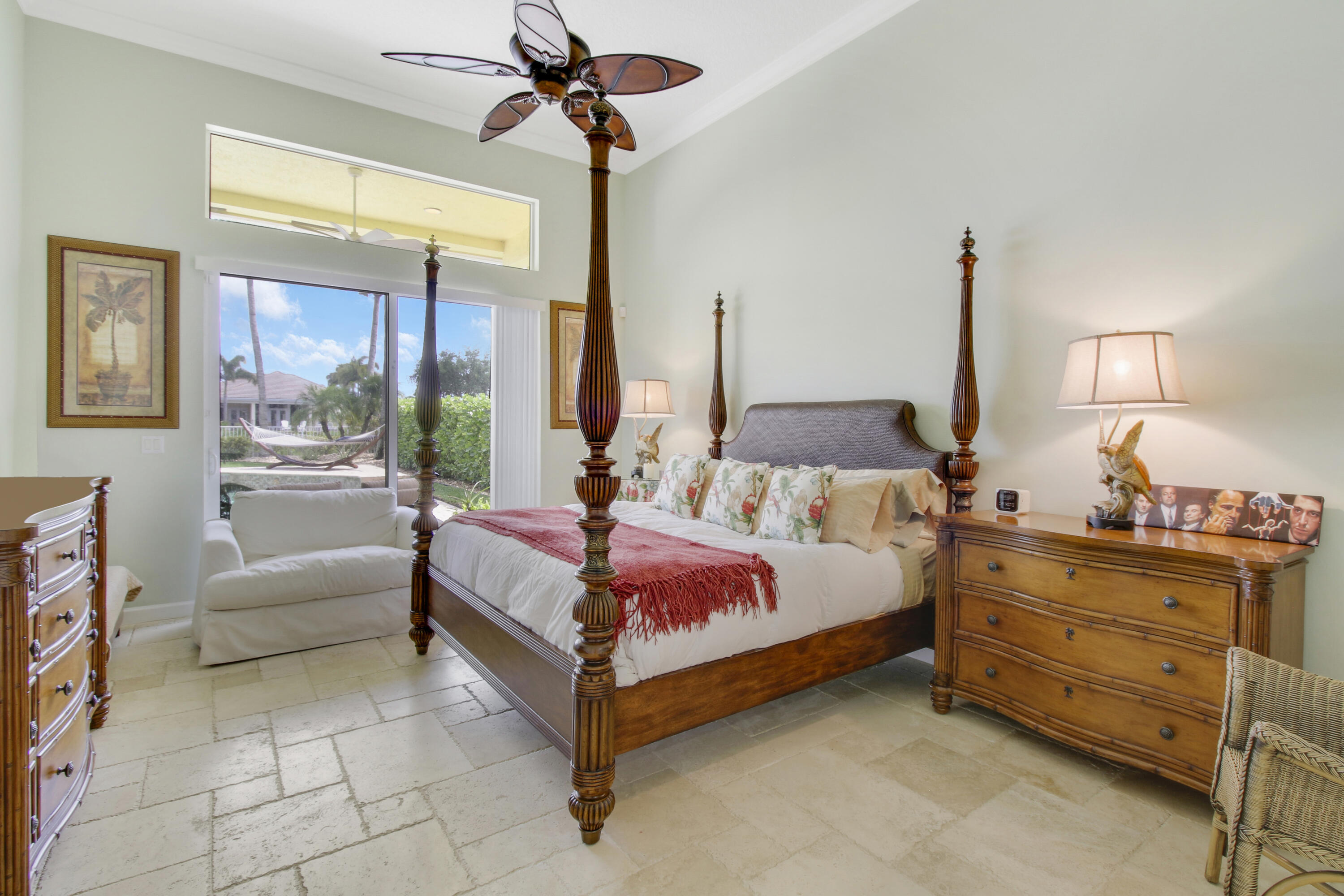 660 Southwest Yacht Basin Way Stuart, FL 34997 - Photo 17 of 42 a spacious bedroom with a bed and a chandelier