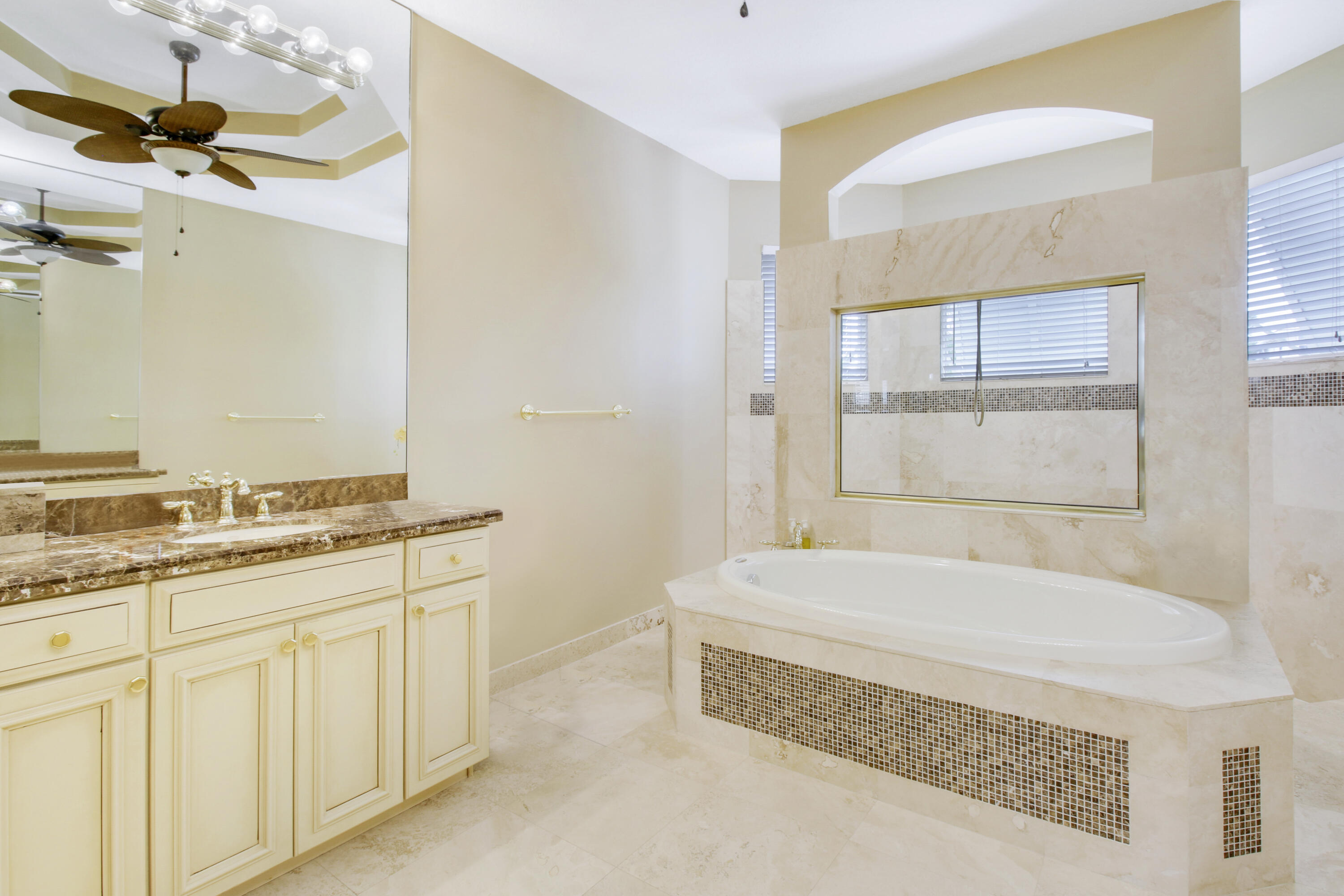 660 Southwest Yacht Basin Way Stuart, FL 34997 - Photo 20 of 42 a bathroom with a granite countertop sink a mirror and a bathtub