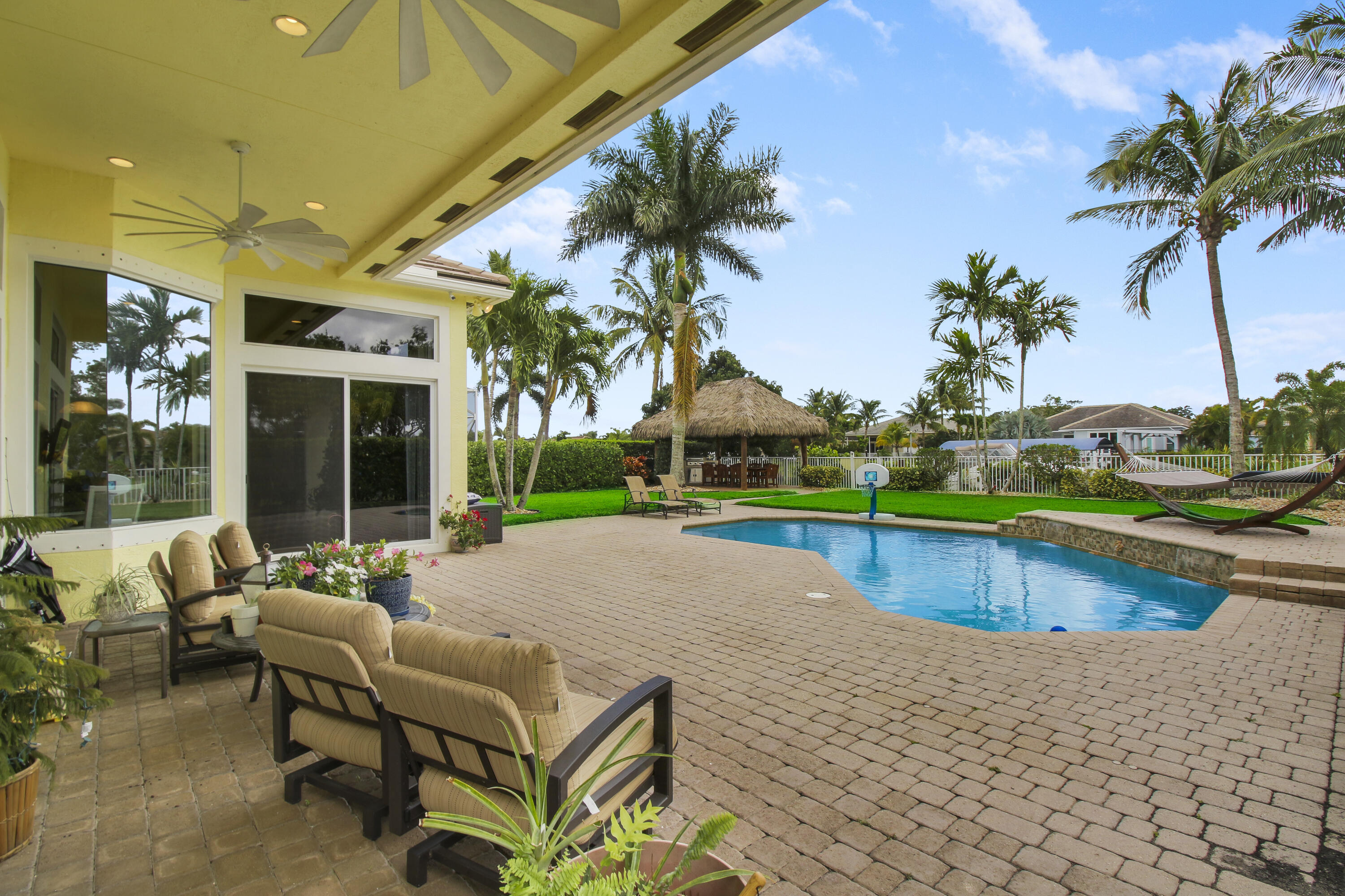 660 Southwest Yacht Basin Way Stuart, FL 34997 - Photo 2 of 42 a swimming pool with outdoor seating and yard