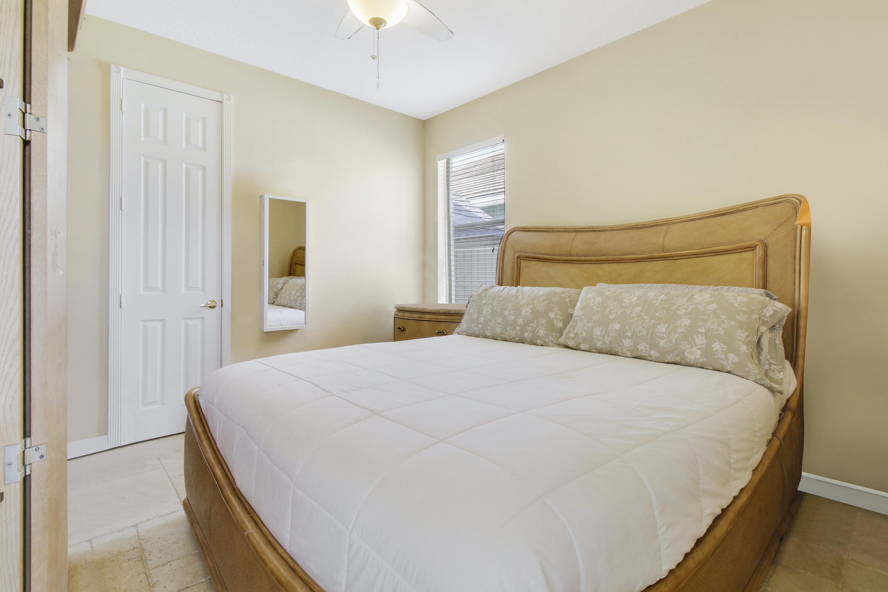 660 Southwest Yacht Basin Way Stuart, FL 34997 - Photo 21 of 42 a bedroom with a bed and a chandelier