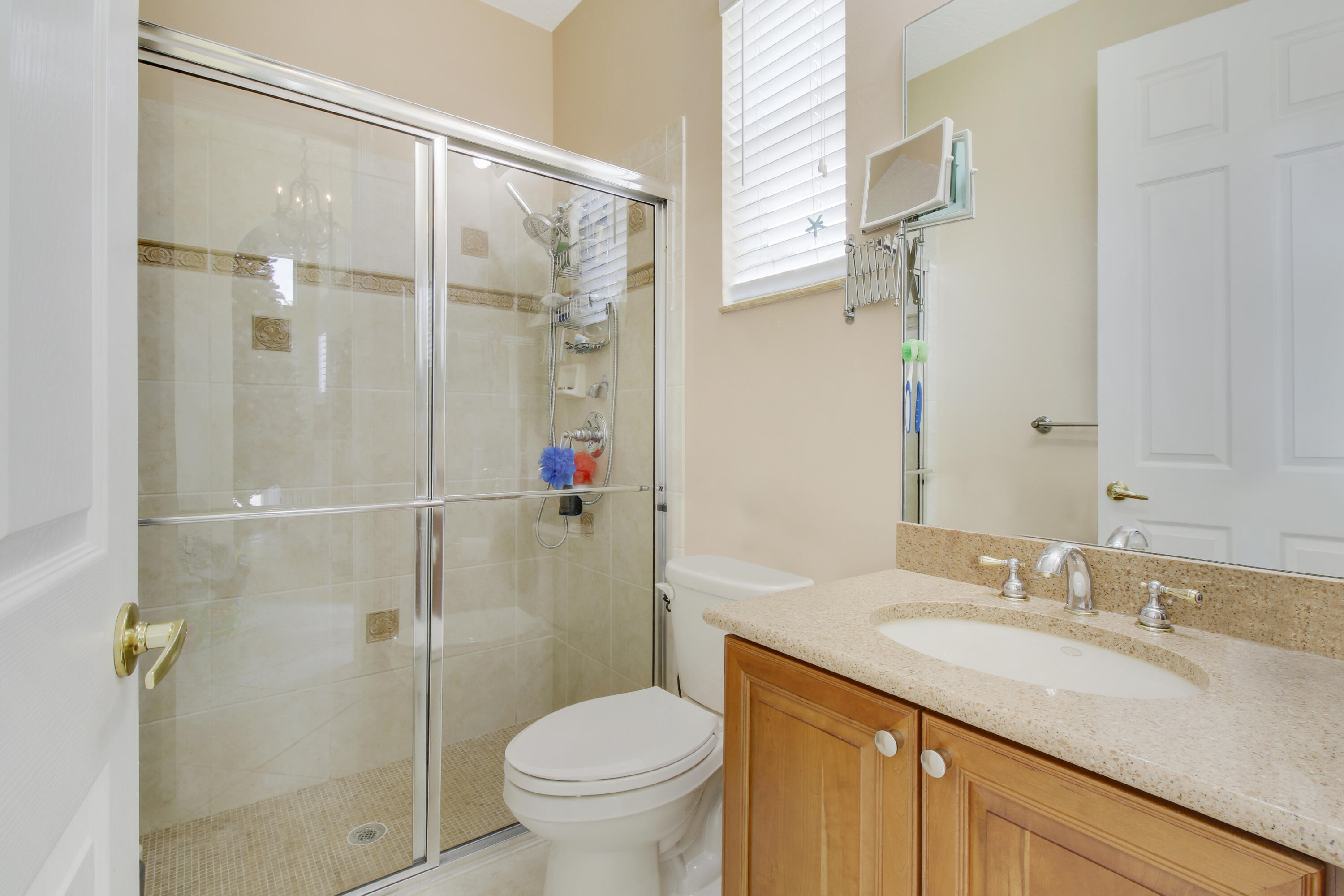 660 Southwest Yacht Basin Way Stuart, FL 34997 - Photo 22 of 42 a bathroom with a granite countertop sink toilet and shower