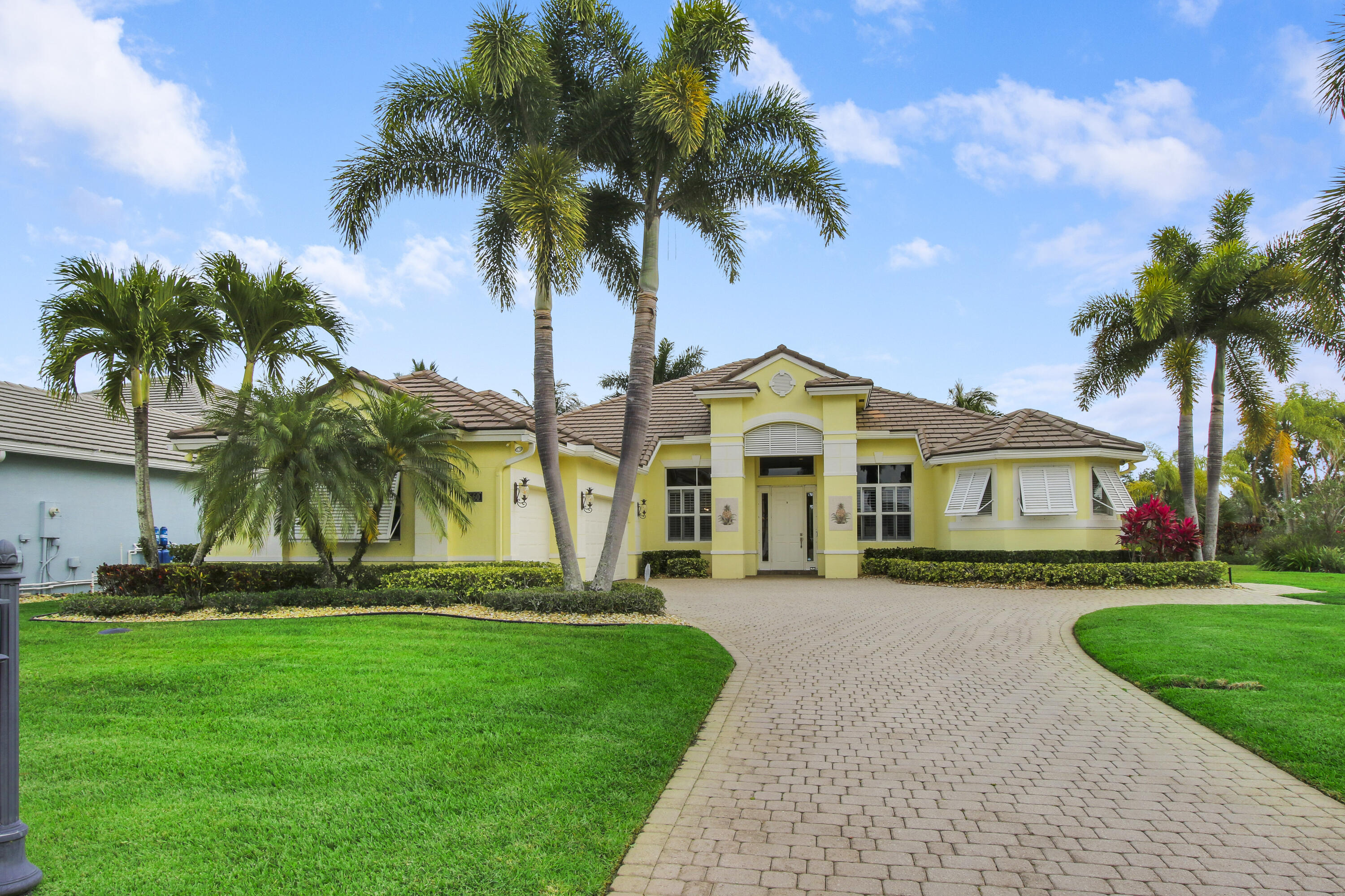 660 Southwest Yacht Basin Way Stuart, FL 34997 - Photo 3 of 42 a front view of a house with a garden and trees