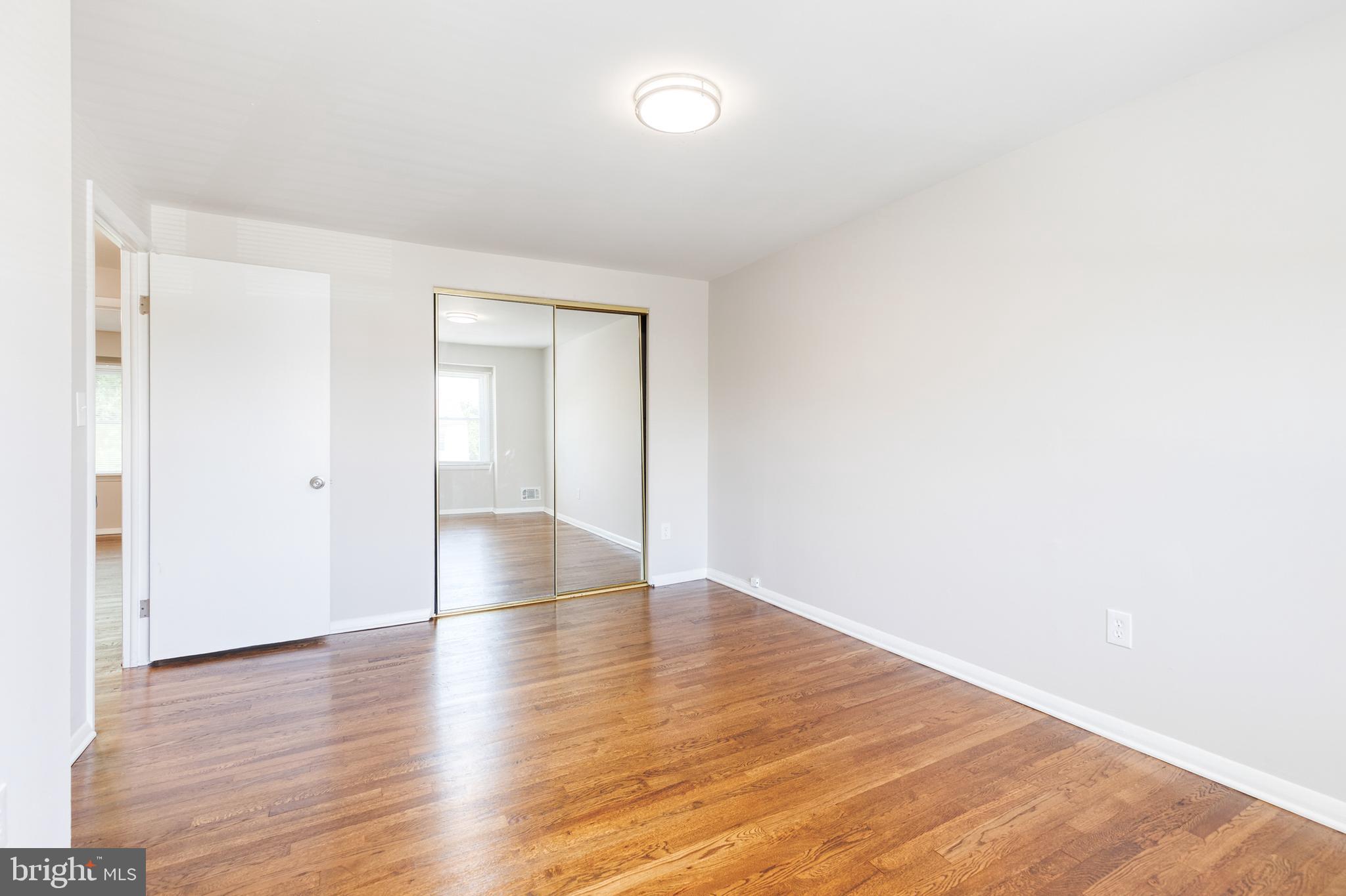 5649 Utrecht Road Baltimore, MD 21206 - Photo 25 of 42 a view of an empty room with wooden floor and a window
