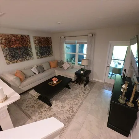 a hallway with a view of kitchen and living room