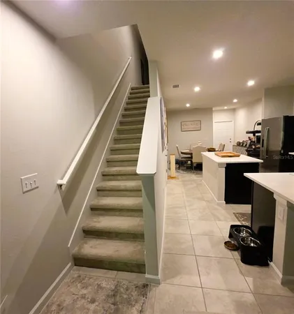 a view of a hallway with wooden floor and closet