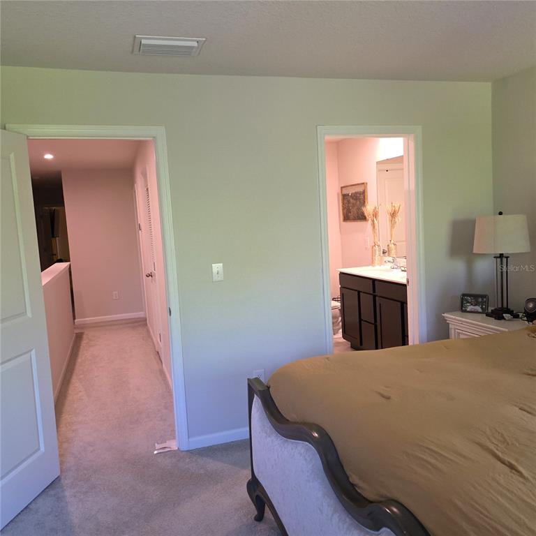 3087 Victoria Inlet Drive Holiday, FL 34691 - Photo 26 of 46 a bed room with a bed and a mirror