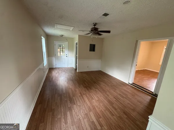 wooden floor in an empty room with a window