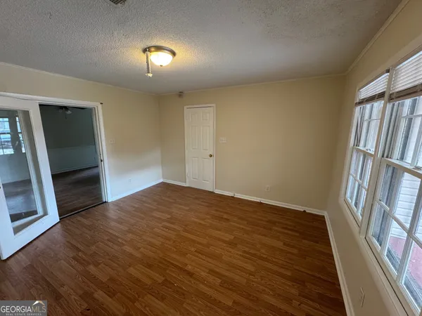 wooden floor in an empty room with a window