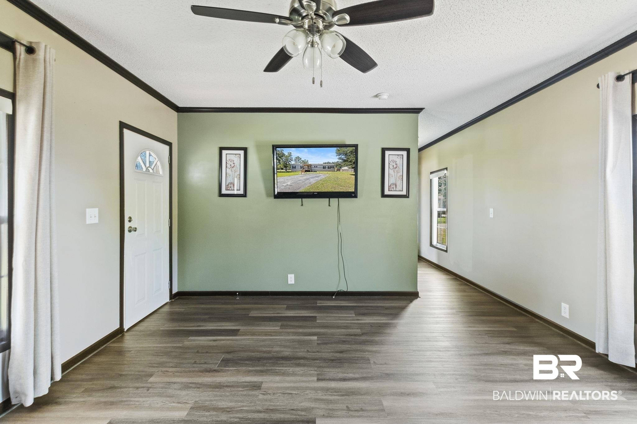 6870 Cecilia Court Theodore, AL 36582 - Photo 14 of 83 Entryway featuring ornamental molding, ceiling fan, dark hardwood / wood-style floors, and a textured ceiling