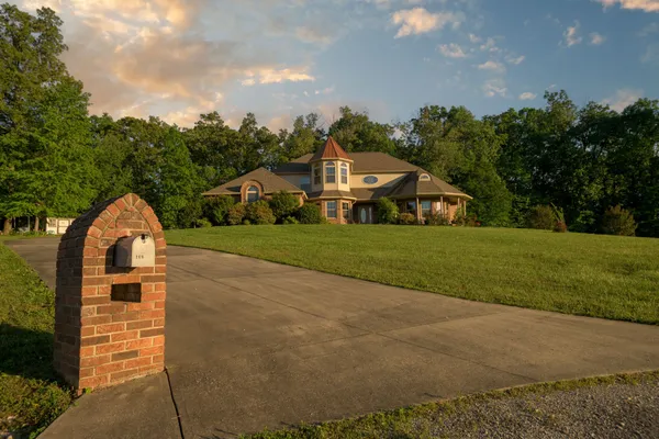 a front view of a house with a yard