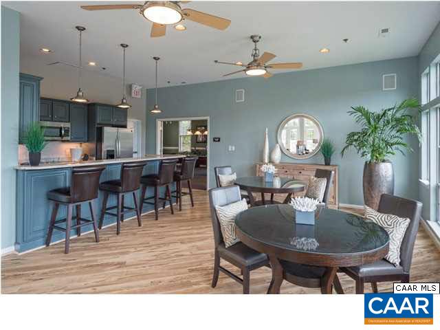 200 Lake Club Court, Unit 3 Charlottesville, VA 22902 - Photo 3 of 16 a dining room with furniture a rug and wooden floor