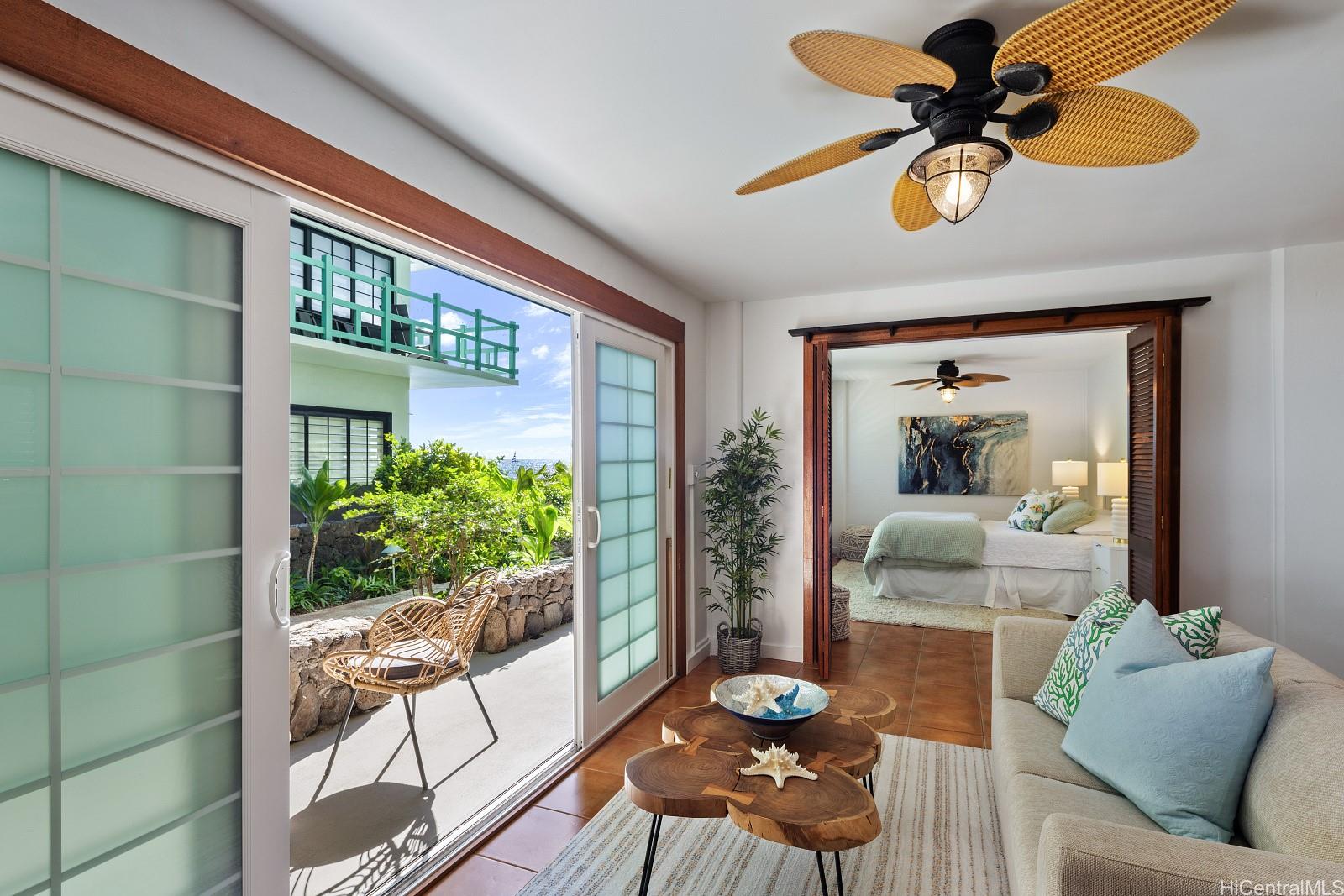 2957 Kalakaua Avenue, Unit 102 Honolulu, HI 96815 - Photo 7 of 15 a living room with furniture and a large window