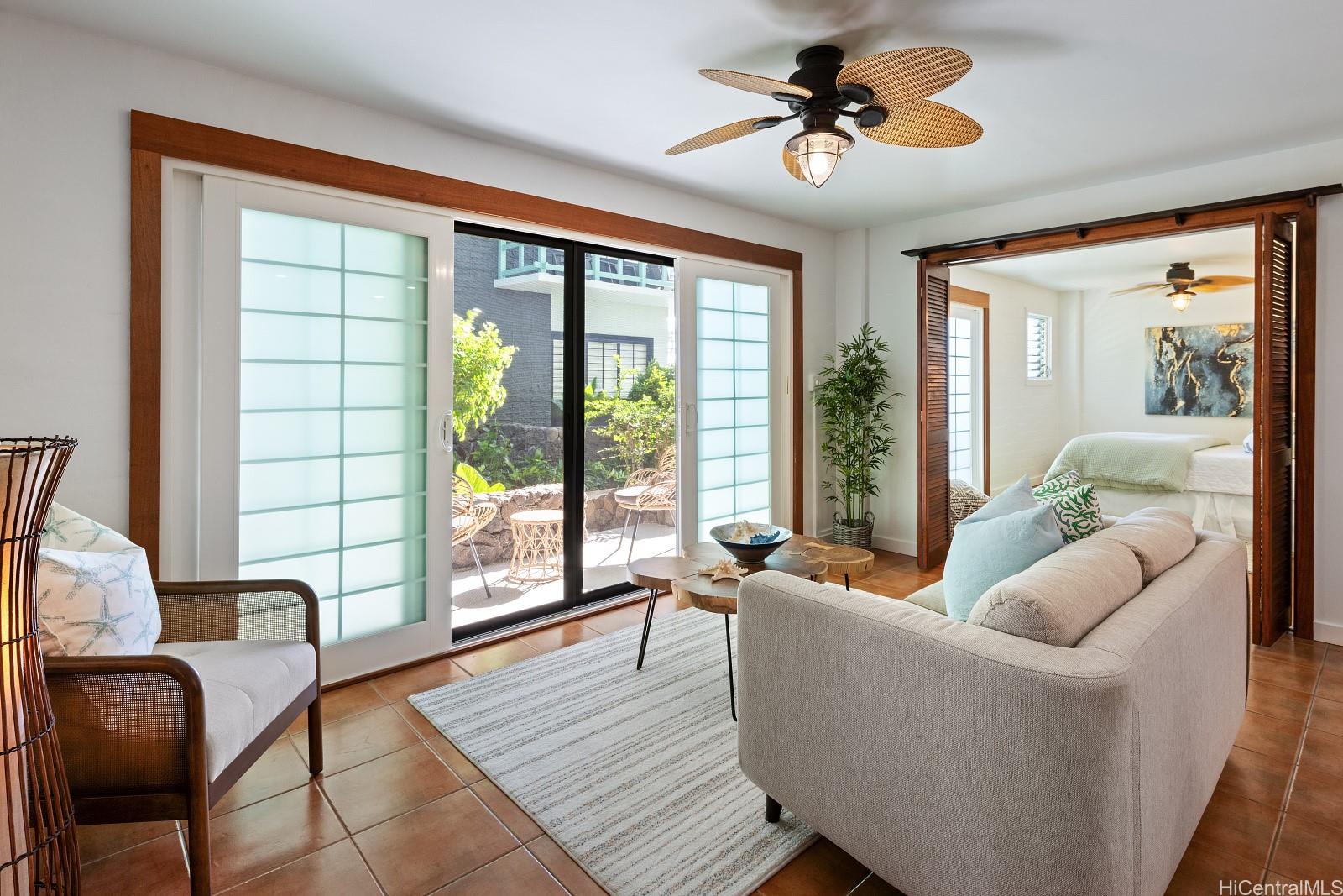 2957 Kalakaua Avenue, Unit 102 Honolulu, HI 96815 - Photo 8 of 15 a living room with furniture and a large window
