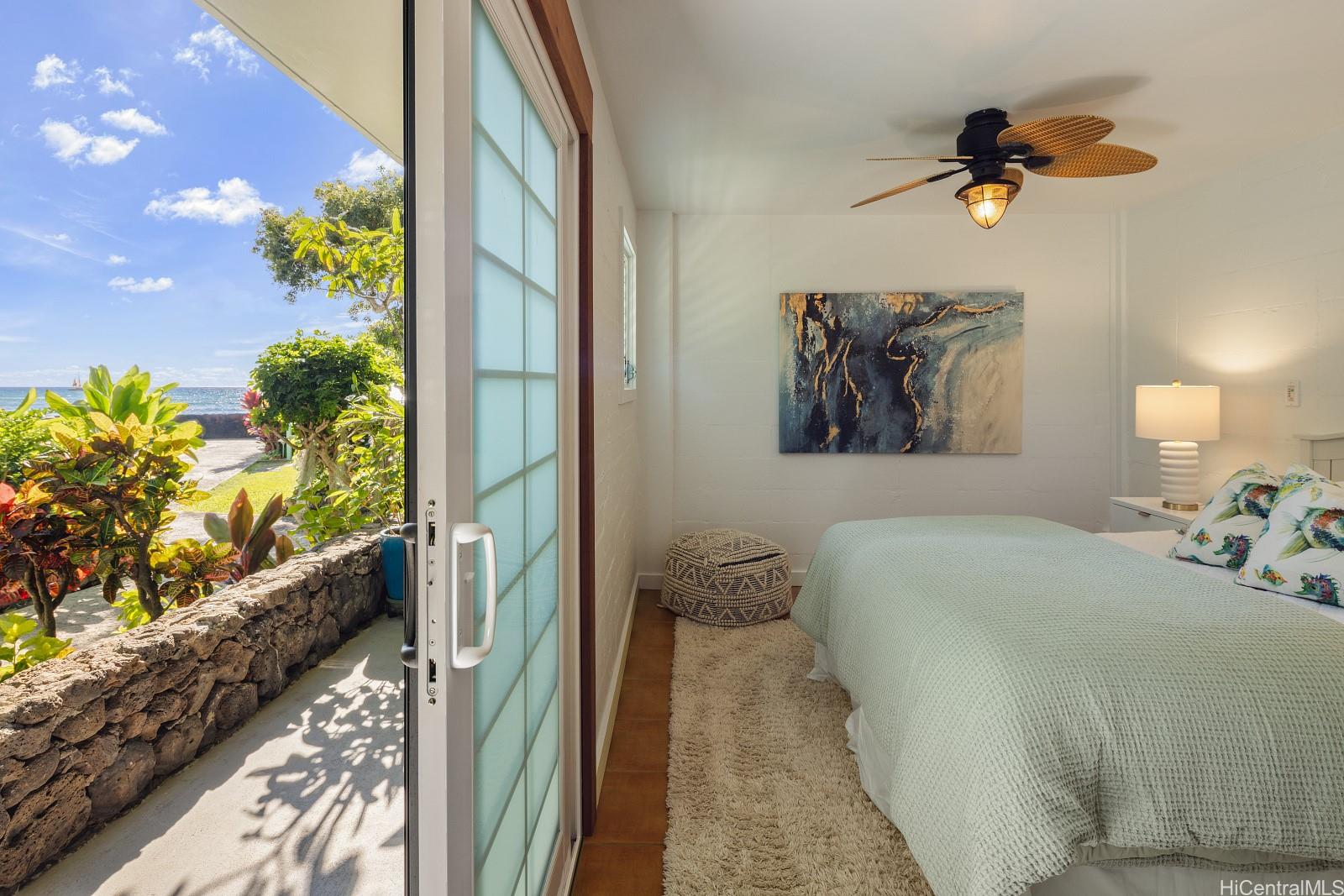 2957 Kalakaua Avenue, Unit 102 Honolulu, HI 96815 - Photo 10 of 15 a bedroom with a bed and a chandelier