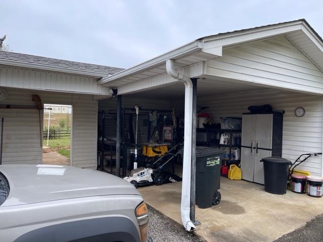 240 Johns Road Toone, TN 38381 - Photo 11 of 22 a view of a garage with a tv and a chair