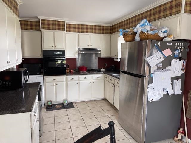 240 Johns Road Toone, TN 38381 - Photo 4 of 22 a kitchen with a sink a refrigerator and cabinets