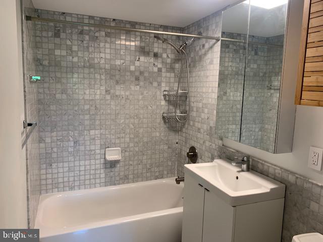 300 M Street Southwest, Unit N411 Washington, DC 20024 - Photo 11 of 13 a bathroom with a sink mirror toilet and bathtub