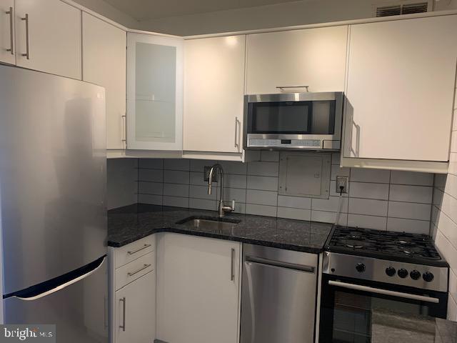 300 M Street Southwest, Unit N411 Washington, DC 20024 - Photo 7 of 13 a kitchen with a sink and a stove top oven