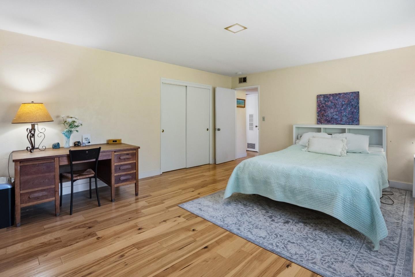 328 Main Street, Unit 13 Santa Cruz, CA 95060 - Photo 13 of 27 a bedroom with a bed and a table in it