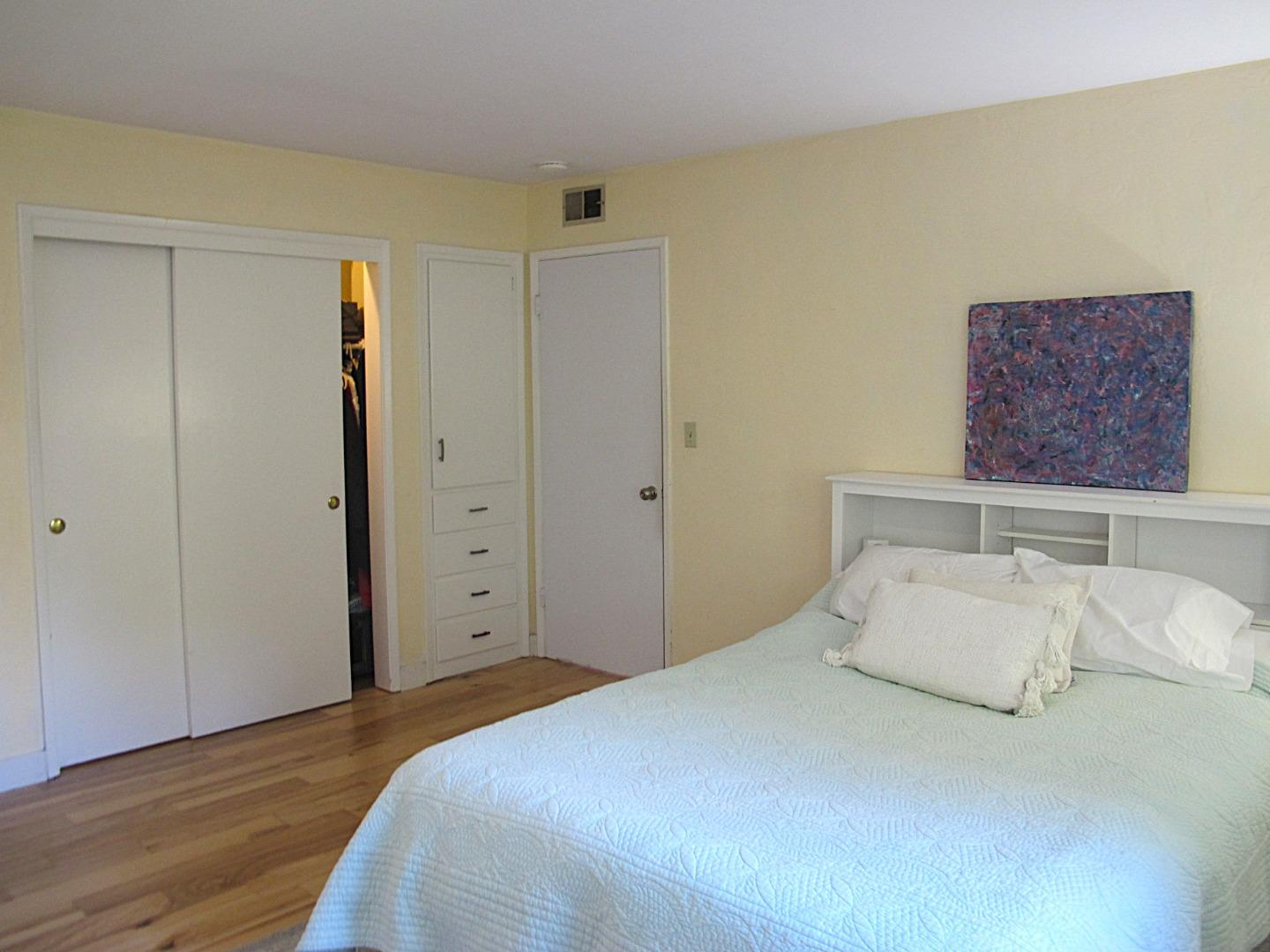 328 Main Street, Unit 13 Santa Cruz, CA 95060 - Photo 14 of 27 a bedroom with a bed and a painting on the wall