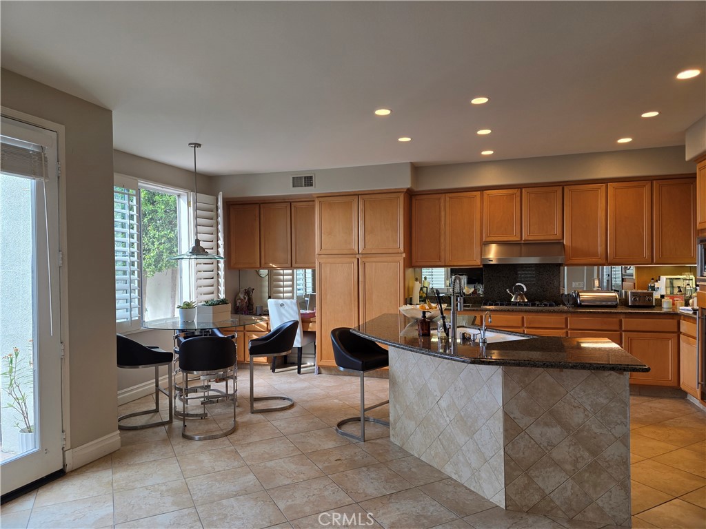 17 Avignon Newport Coast, CA 92657 - Photo 11 of 19 a kitchen with kitchen island granite countertop a living room cabinets and living room view