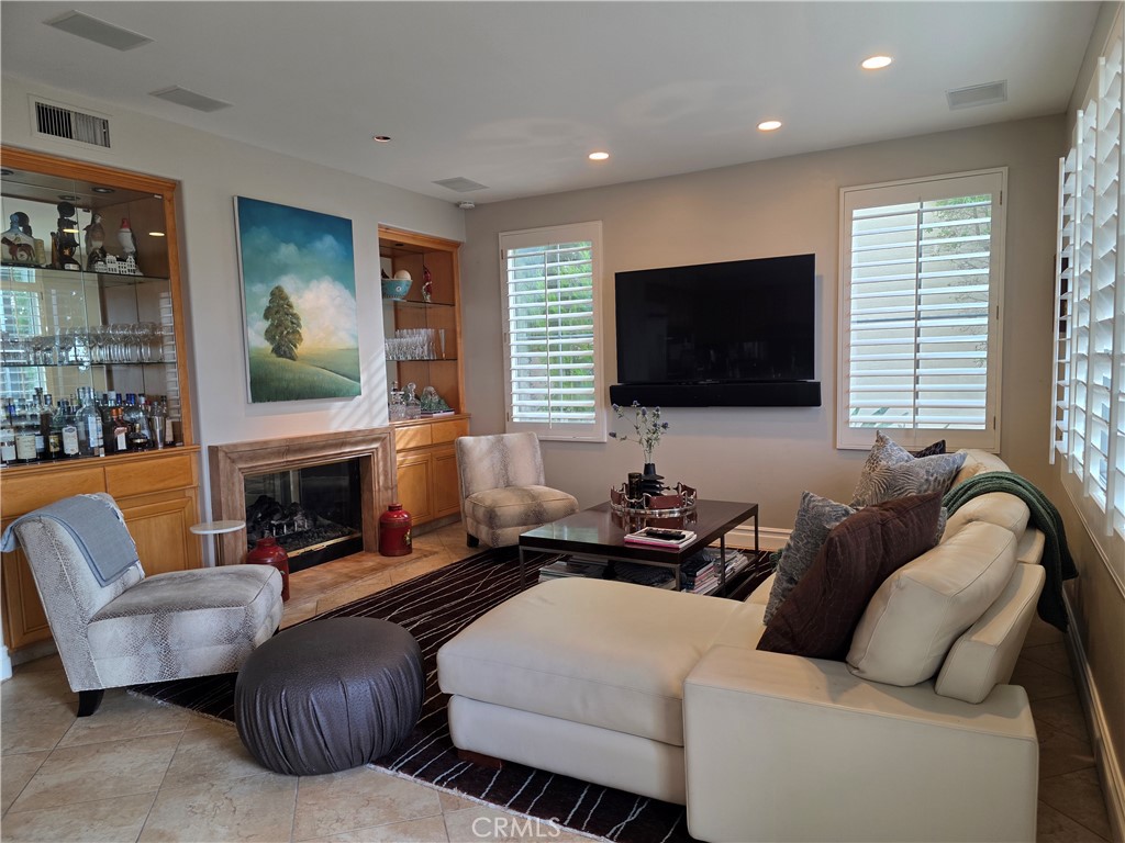 17 Avignon Newport Coast, CA 92657 - Photo 10 of 19 a living room with furniture a fireplace and a flat screen tv