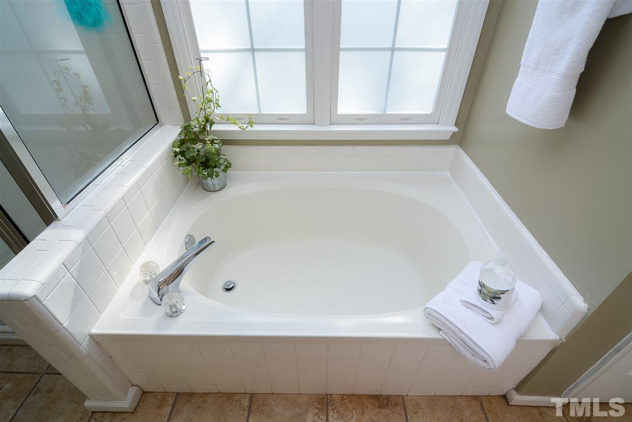 4404 Labrador Drive Raleigh, NC 27616 - Photo 12 of 25 a bath tub sitting in a bathroom next to a window