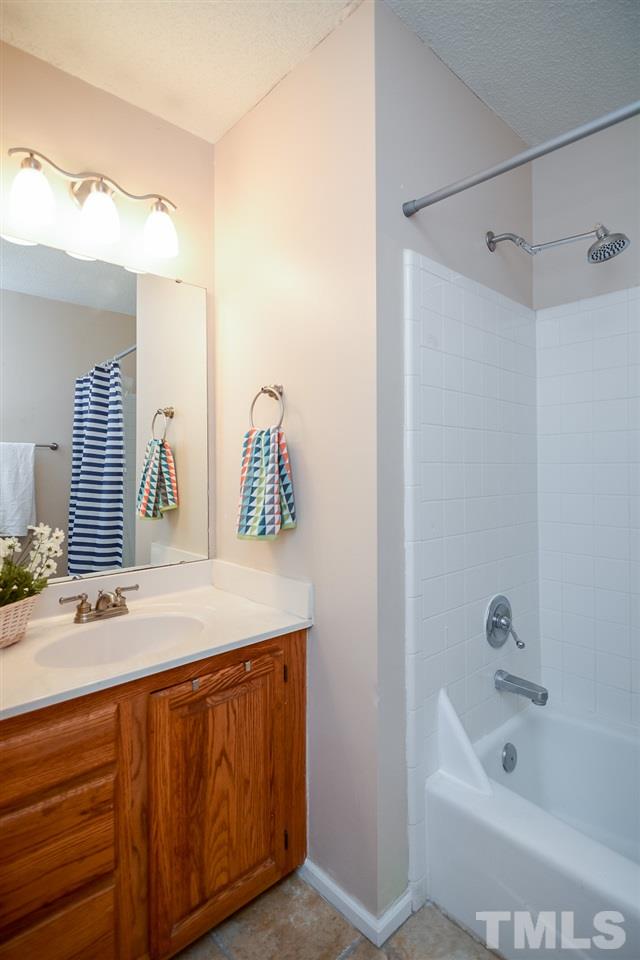 4404 Labrador Drive Raleigh, NC 27616 - Photo 15 of 25 a bathroom with a tub sink and mirror