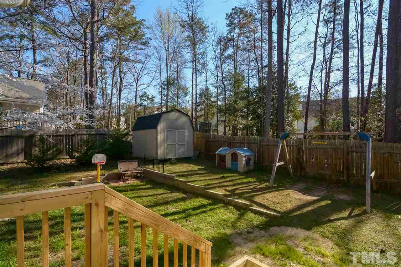 4404 Labrador Drive Raleigh, NC 27616 - Photo 18 of 25 a view of a backyard with chairs and a fire pit