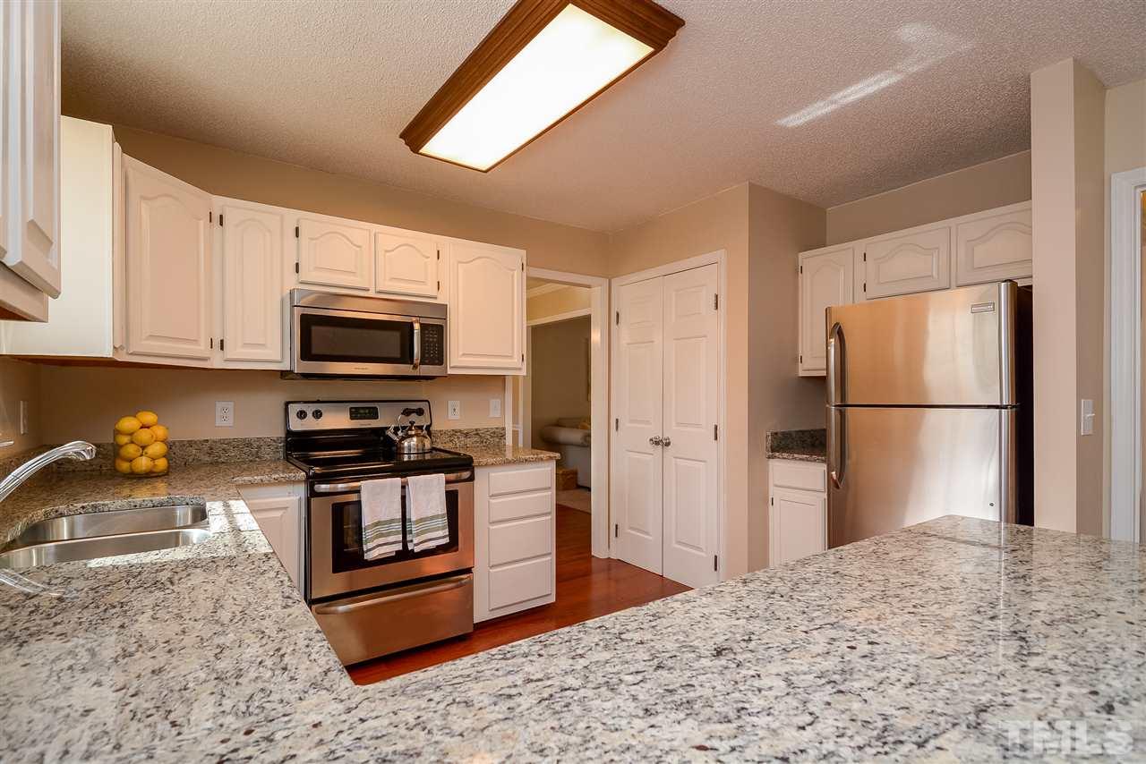 4404 Labrador Drive Raleigh, NC 27616 - Photo 4 of 25 a kitchen with stainless steel appliances granite countertop a refrigerator stove and microwave