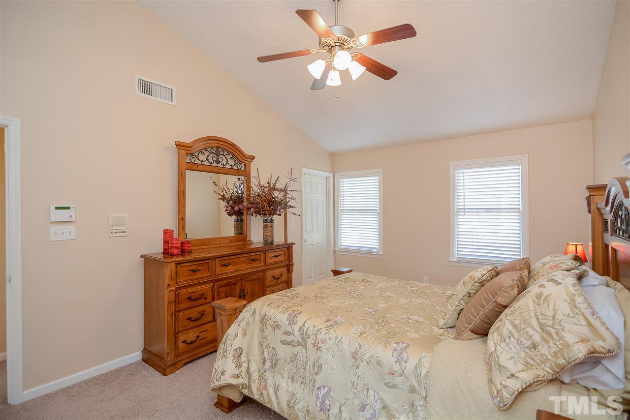 4404 Labrador Drive Raleigh, NC 27616 - Photo 10 of 25 a bedroom with a bed and a dresser in it