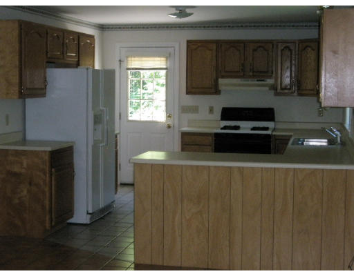 18 Blodgett Road Holland, MA 01521 - Photo 4 of 13 a kitchen with a refrigerator and a stove